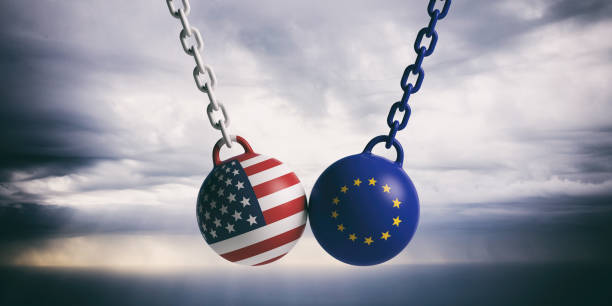 istock USA and EU flags wrecking balls swinging on blue cloudy sky background. 3d illustration 1048647836