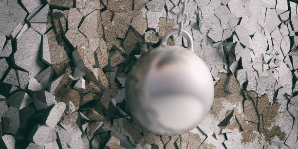 istock Wrecking ball hitting and breaking a silver wall. 3d illustration 1048647894