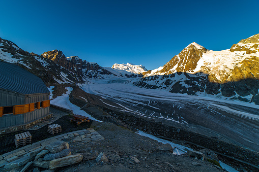 Scenic view of beautiful landscape of Swiss Alps with a majestic Glacier de Corbassiere in a view, Switzerland. Clear sky sunrise in Valais Alps (Pennine Alps), Switzerland in a early morning light. Cold morning in a mountains.