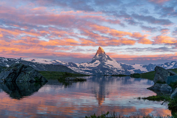 Morning shot of the golden Matterhorn mountain and blue Stellisee lake. stock photo