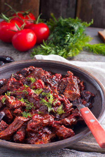 istock Stewed beef in tomato sauce with prunes, selective focus 1048660512