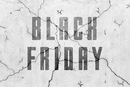 Blank concrete grey wall with crack texture background and words black friday