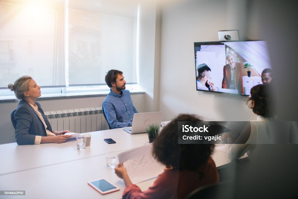Business Meeting Group of young business people discussing with colleagues  on video conference on meeting. Video Conference Stock Photo