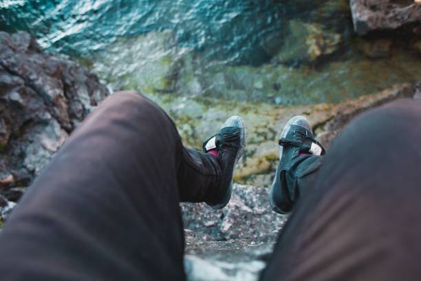 istock Feet Hang Over Edge Photo 1048666554