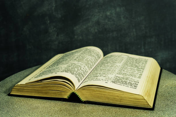 istock Bible on a round white table. Beautiful dark background. Religious concept. 1048669348
