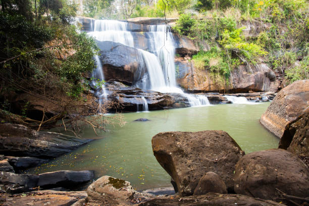 istock beautiful waterfall in forest with rock foreground 1048677374