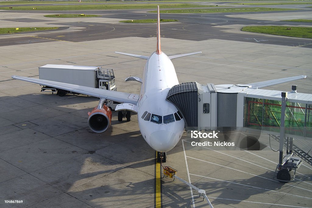 Aircraft on stand at Gatwick Airport. England Passenger aircraft on the stand being refueled and restocked at Gatwick (London) Airport, West Sussex, England Light Goods Vehicle Stock Photo