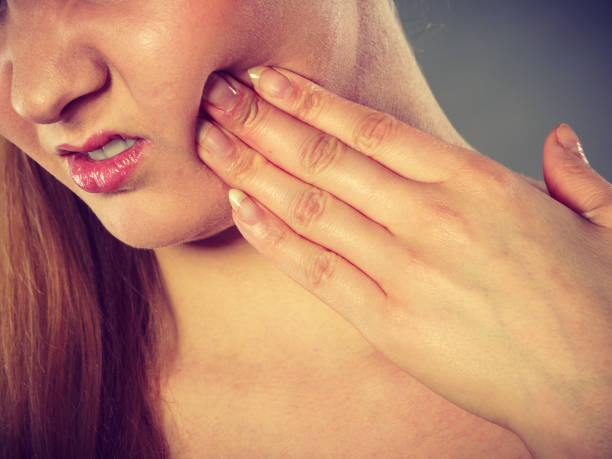 istock Woman suffering from tooth pain 1048680004