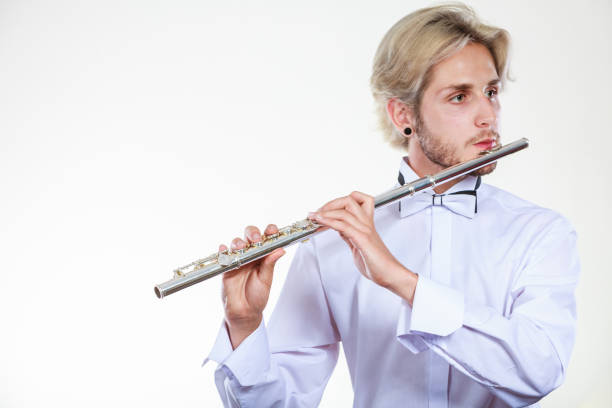istock Male flutist playing his flute 1048680186
