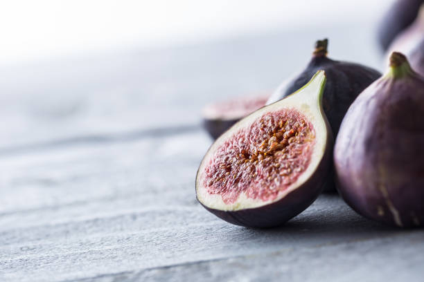 istock A few figs freely lying on old wooden table. 1048680958