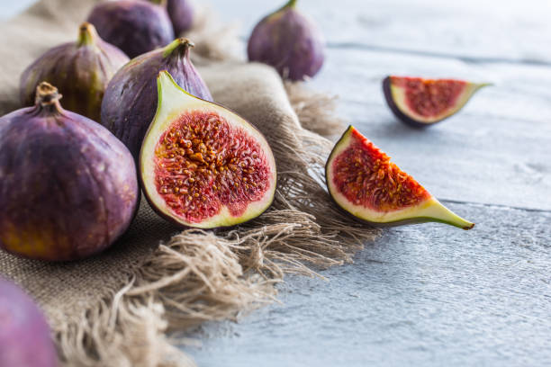 istock A few figs freely lying on old wooden table. 1048680972