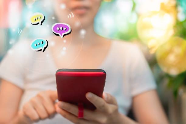 istock Women hand using smartphone typing, chatting conversation in chat box icons pop up. Social media maketing technology concept.Vintage soft color tone background. 1048683224