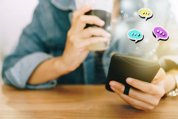istock Women hand using smartphone typing, chatting conversation in chat box icons pop up. Social media maketing technology concept.Vintage soft color tone background. 1048683228
