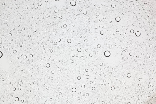 istock Rain droplets on glass background, Water drops on glass. 1048683800