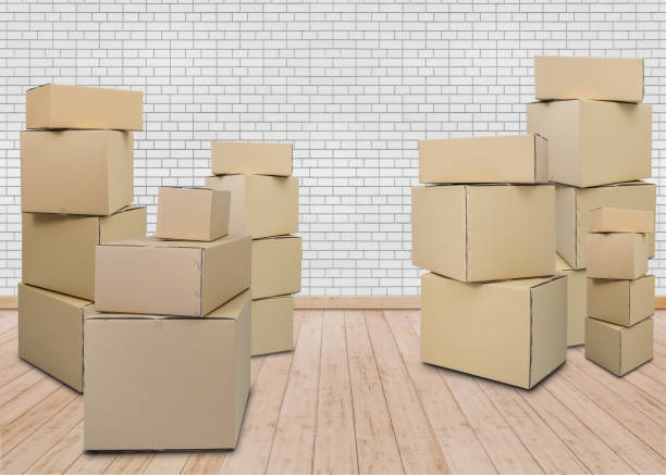 istock Moving in new home. Empty room with Carton boxes 1048684096