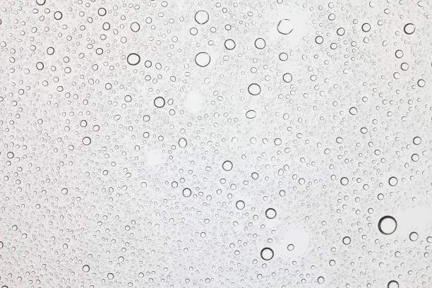 istock Rain droplets on glass background, Water drops on glass. 1048686384
