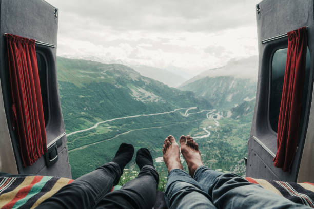 Couple laying with view on Furka pass Couple laying with view on Furka pass. Personal perspective furka pass photos stock pictures, royalty-free photos & images