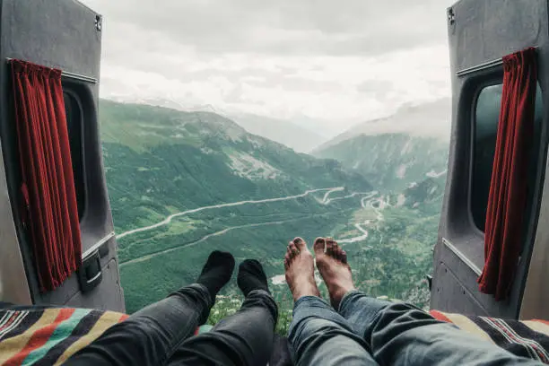 Couple laying with view on Furka pass. Personal perspective