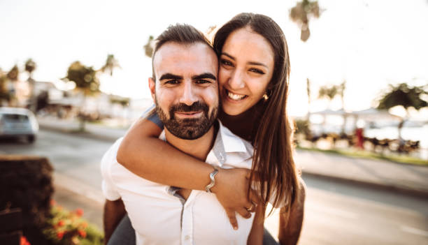 istock piggybacking couple at dusk on vacation 1048690932