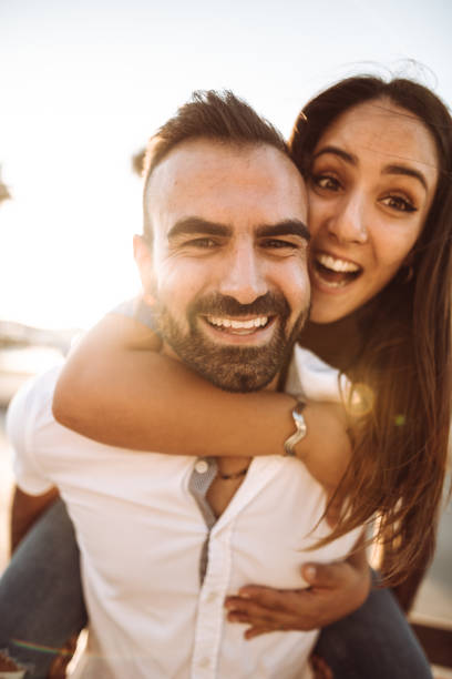 istock piggybacking couple at dusk on vacation 1048691890
