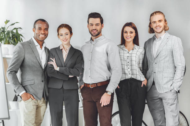 istock smiling multicultural businesspeople standing and looking at camera 1048701626