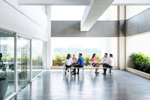 istock Modern open plan office space with business people 1048702210
