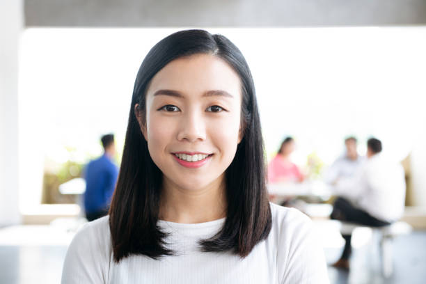 istock Cheerful young Chinese woman smiling towards camera 1048702216