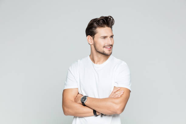istock Muscular man standing with his arms crossed 1048702346