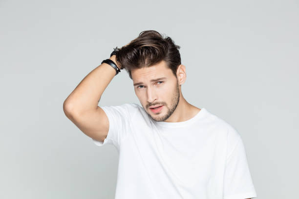 istock Attractive young man posing with hand in hair 1048702516