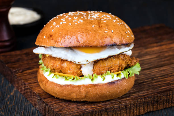 istock Burger on a wooden board 1048702602