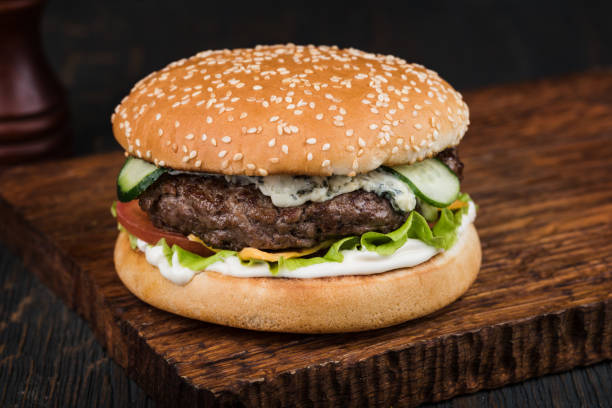 istock Burger on a wooden board 1048702606
