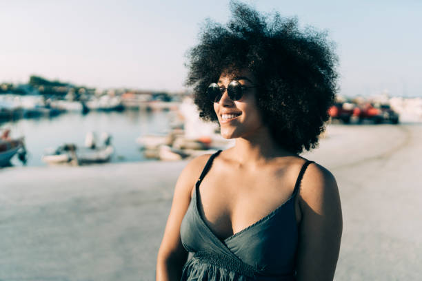 istock Smiling woman walking on street 1048707840