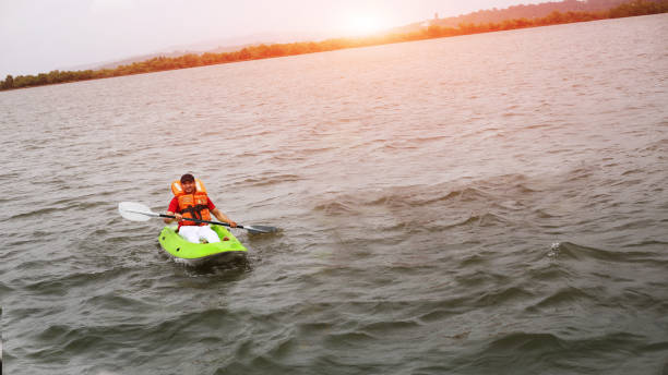 istock Young men boating in Mandovi river, Goa 1048708112