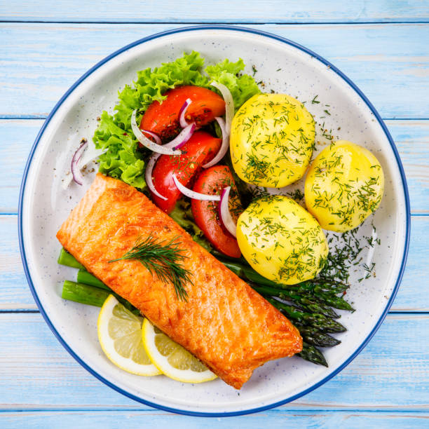 istock Grilled salmon with boiled potatoes and vegetable salad 1048710996