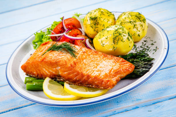 istock Grilled salmon with boiled potatoes and vegetable salad 1048712406