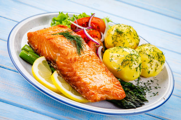 istock Grilled salmon with boiled potatoes and vegetable salad 1048712540