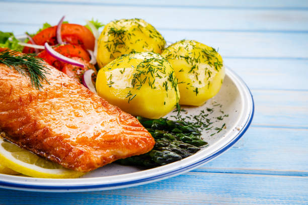 istock Grilled salmon with boiled potatoes and vegetable salad 1048715514