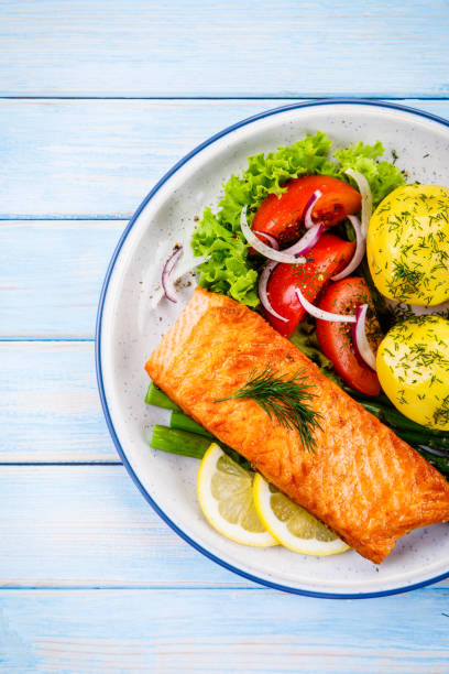 istock Grilled salmon with boiled potatoes and vegetable salad 1048721520
