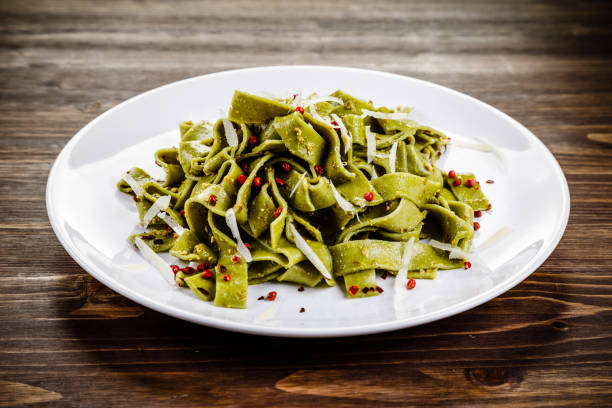 istock Pasta with parmesan on wooden background 1048724810
