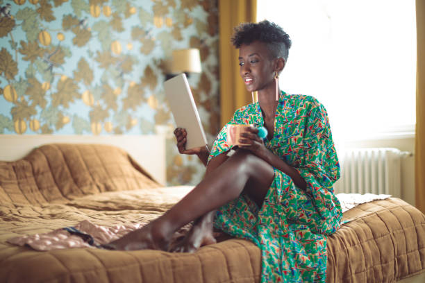 istock Young woman is browsing the internet at home 1048729982