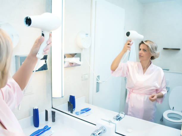 istock Woman drying hair 1048730244