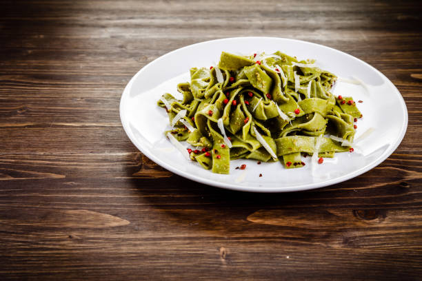 istock Pasta with parmesan on wooden background 1048734636