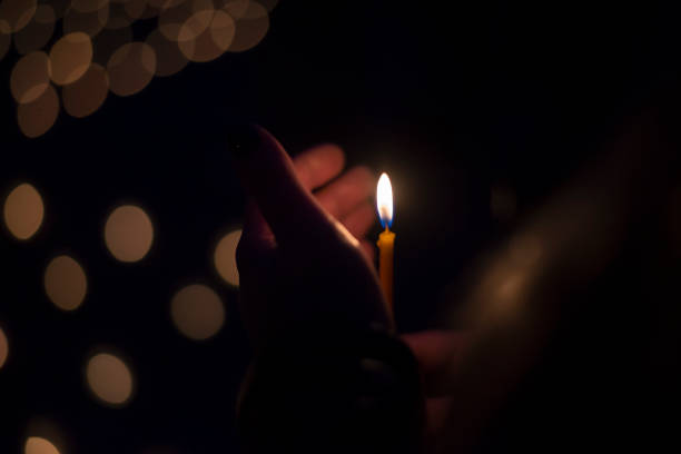 istock Hand holding a burning candle in the dark 1048735376