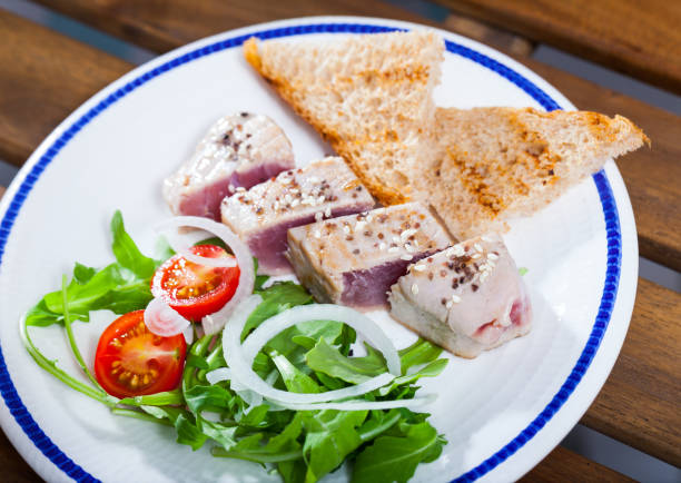 istock Seared tuna steaks with greens and grilled bread 1048736370