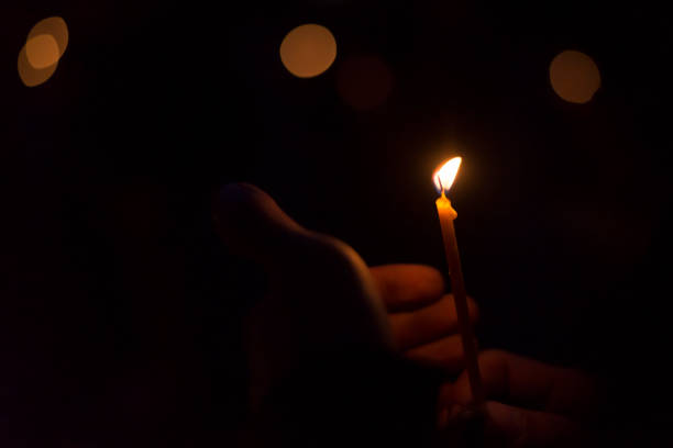 istock Hand holding a burning candle in the dark 1048739498