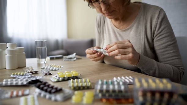 istock Old lady obsessed with healthcare drinking pill, overdose, self-medication 1048744670