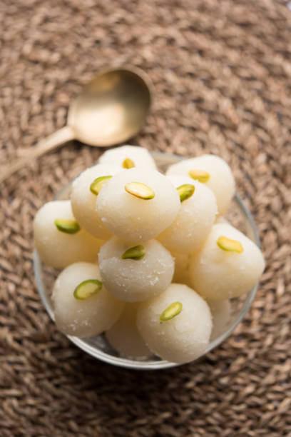 Indian Rasgulla or dry Rosogulla dessert/sweet served in a bowl. selective focus Indian Rasgulla or dry Rosogulla dessert/sweet served in a bowl. selective focus rosogolla stock pictures, royalty-free photos & images