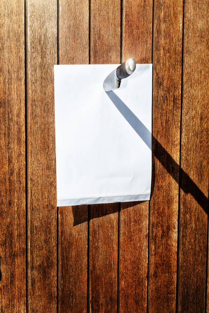 istock Blank sheet of paper held on door by large knife 1048751112