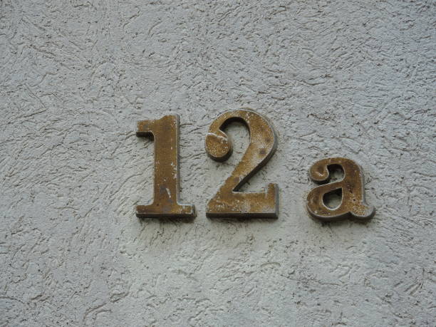 istock House number 12-a on the gray wall 1048756132