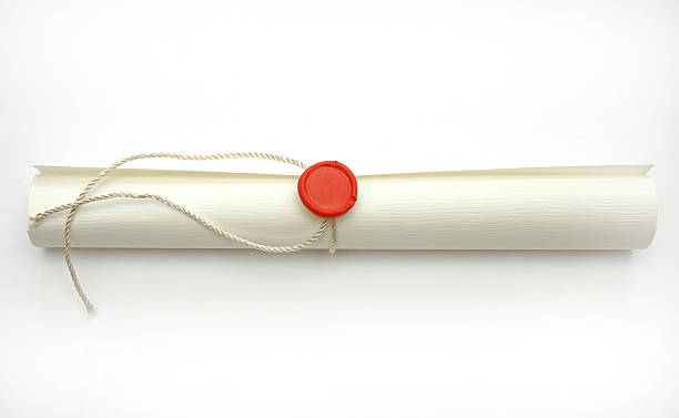 A tied up scroll of paper on a white backing stock photo